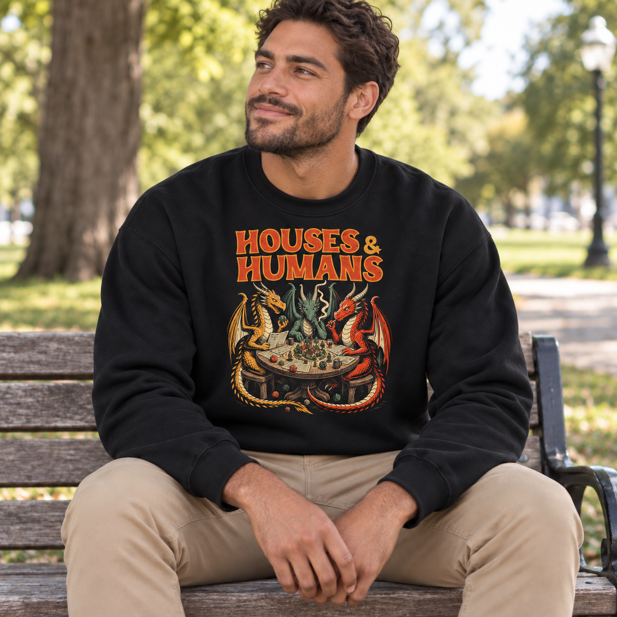 Man wearing Houses & Humans black DnD sweatshirt in a park