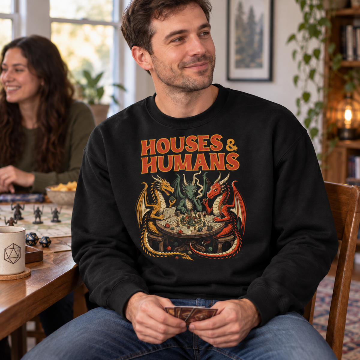 Man wearing Houses & Humans black DnD sweatshirt at game night