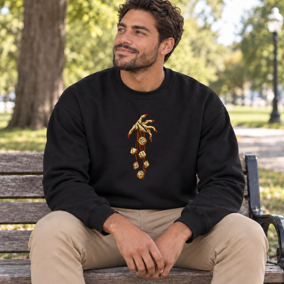Roll of Fate black DnD sweatshirt worn by a man in a park