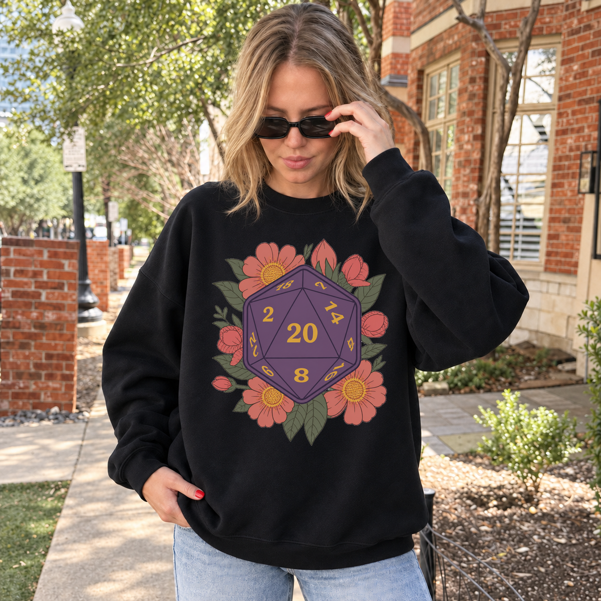 Floral D20 black DnD sweatshirt worn by a woman outdoors
