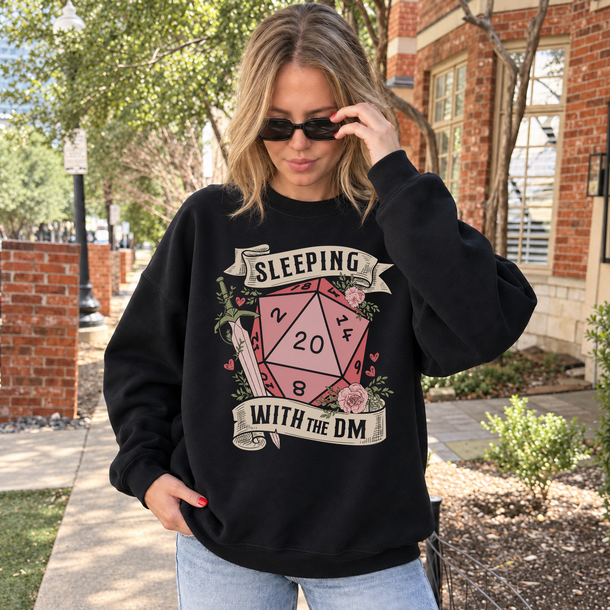 Sleeping with the DM black DnD sweatshirt worn by a woman outdoors