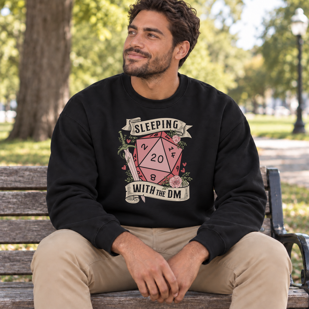 Sleeping with the DM black DnD sweatshirt worn by a man in a park