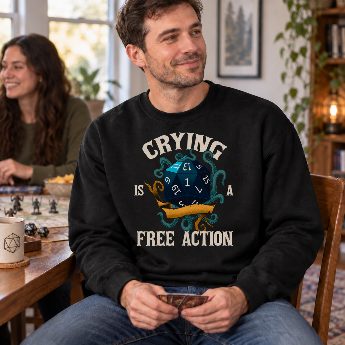 Crying Is a Free Action black DnD sweatshirt worn by a man at game night