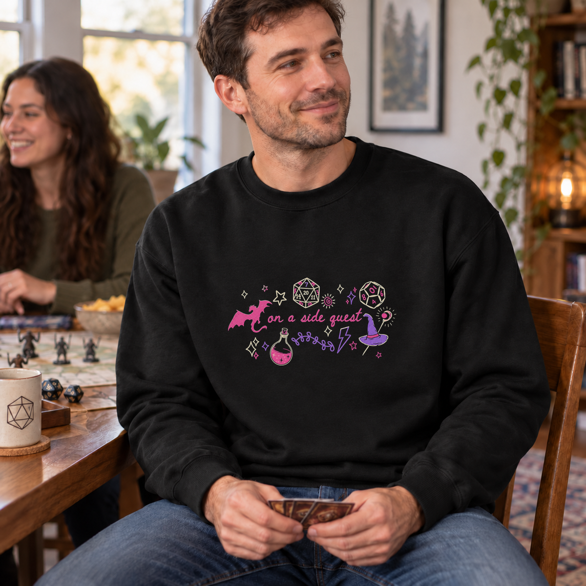 On a Side Quest black DnD sweatshirt worn by a man at game night