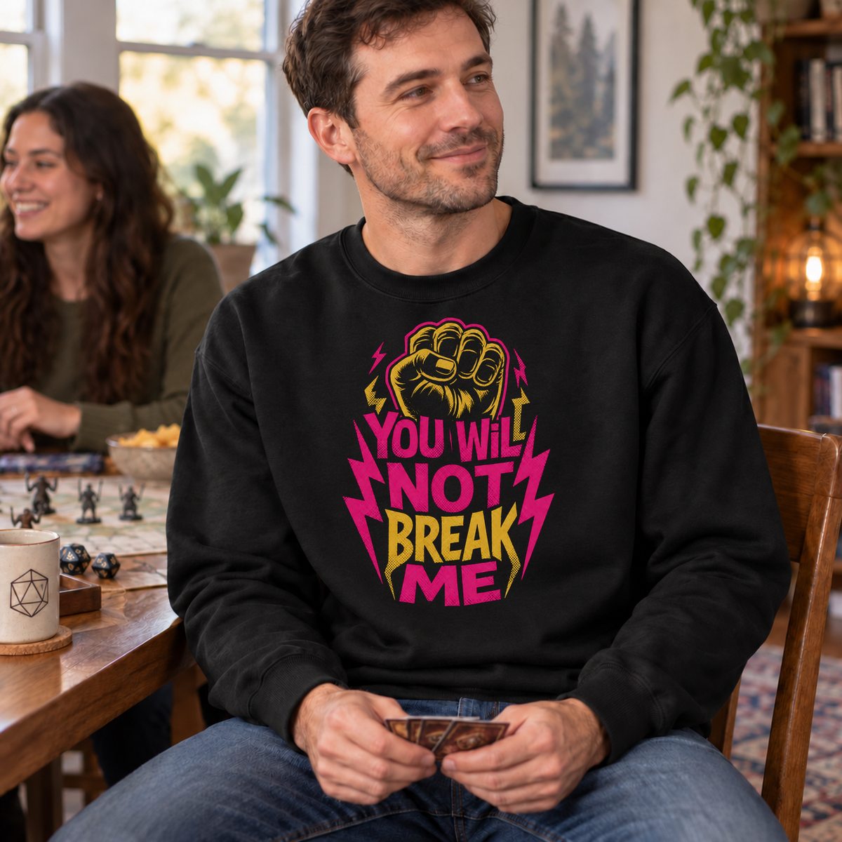 You Will Not Break Me black DnD sweatshirt worn by a man at game night