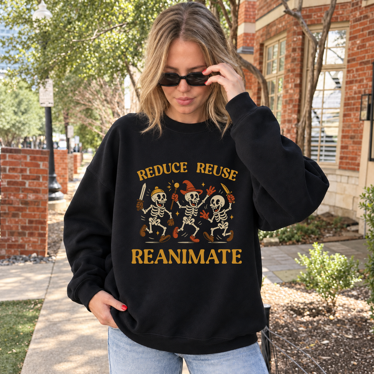 Reduce Reuse Reanimate black DnD sweatshirt worn by a woman outdoors