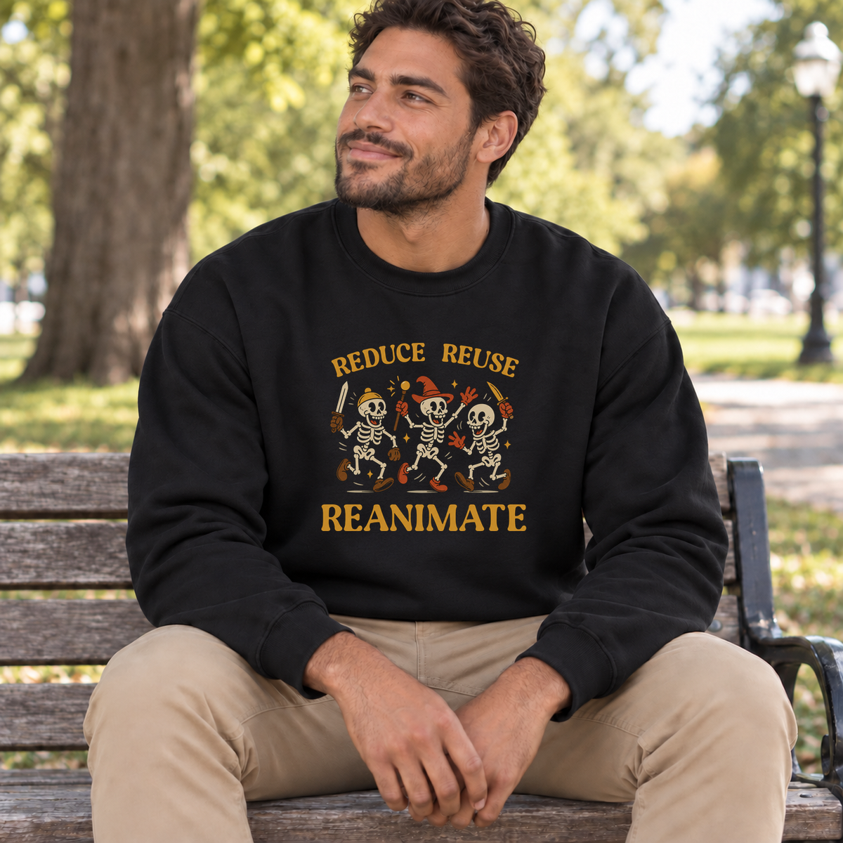 Reduce Reuse Reanimate black DnD sweatshirt worn by a man in a park