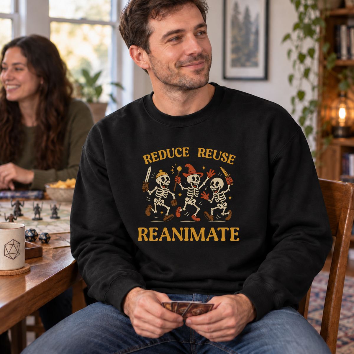 Reduce Reuse Reanimate black DnD sweatshirt worn by a man at game night