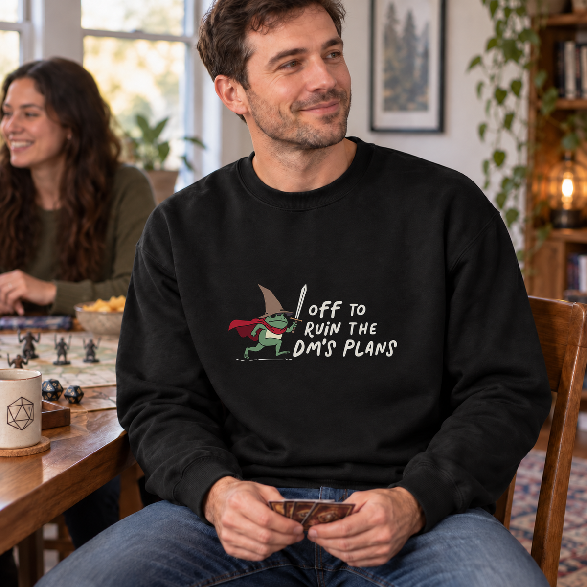 Off to Ruin the DM’s Plans black DnD sweatshirt worn by a man at game night