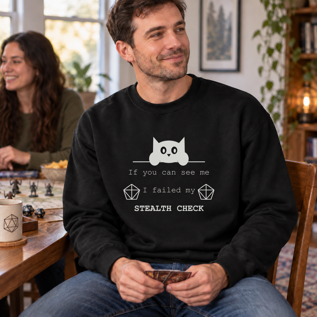 Failed Stealth Cat black DnD sweatshirt worn by a man at game night